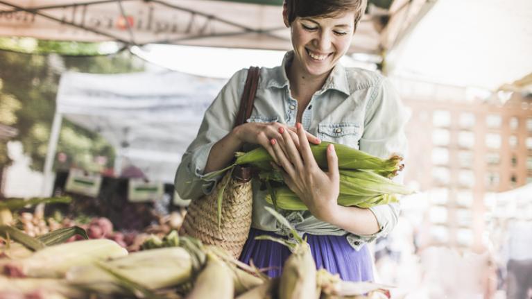 Mujer eligiendo productos de un mercado local 